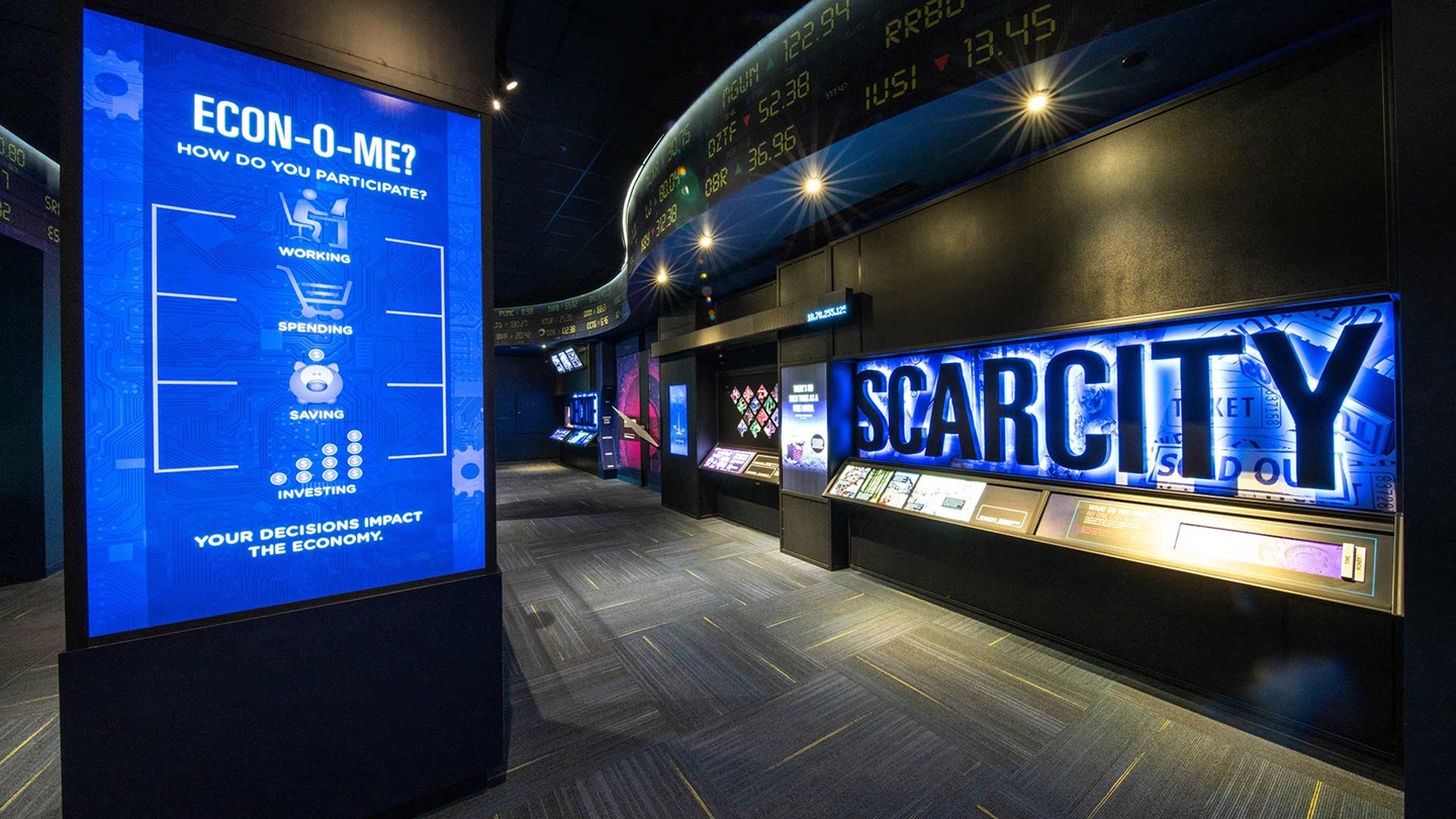 Exhibit with a large sign that reads scarcity with a neon glow.