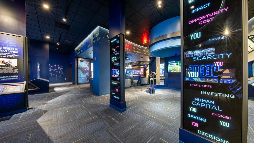 The empty Economy Museum with several large digital displays in view.